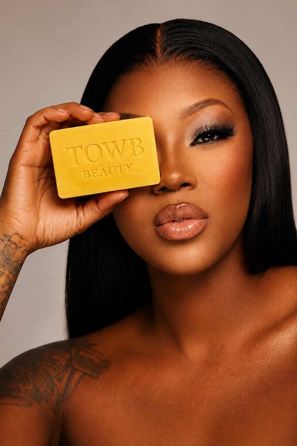 Towb Beauty model holding the sulfur soap bar in a luxury beauty campaign